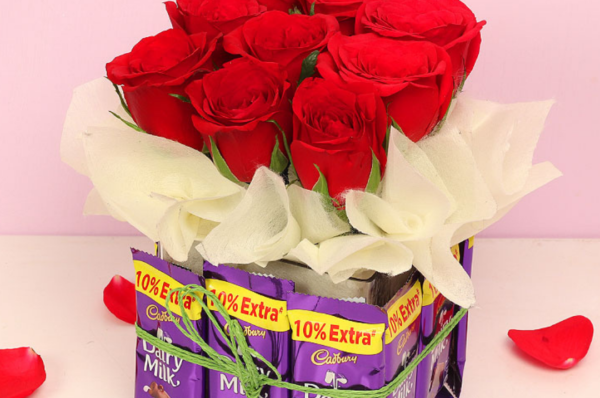 fresh roses with chocolate vase